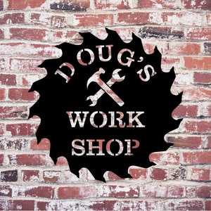 May include: Black metal sign shaped like a saw blade with the text "Doug's Workshop" and a hammer and wrench crossed over each other.