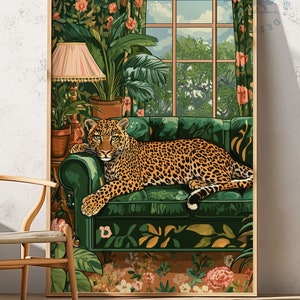 May include: A green velvet sofa with a leopard print lying on it. The sofa is in a room with a large window and lush green plants. The room is decorated with a floral pattern.