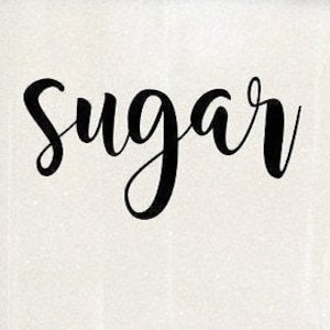 May include: A white ceramic jar with black cursive lettering that reads "Sugar".