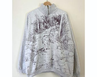 Felpa vintage anni '90 con illustrazione grafica di un lupo e della natura.