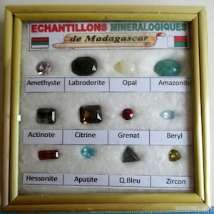 A cute glass topped box with a selection of beautiful gems inside