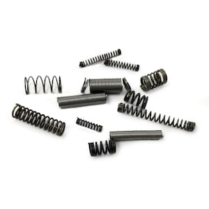 May include: A collection of metal springs of various sizes and shapes, scattered on a white background.