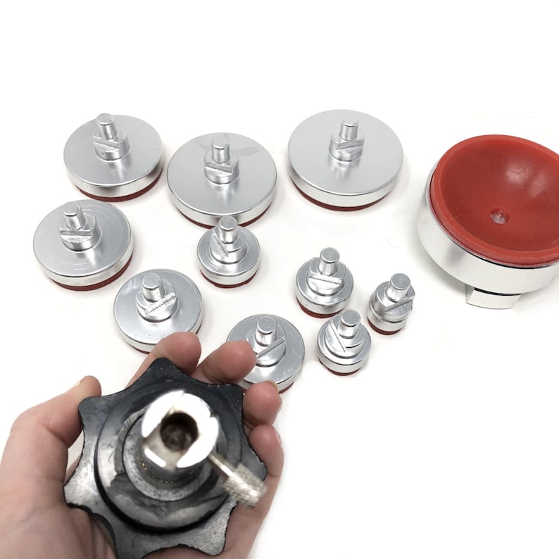 May include: A set of 10 silver suction cups with red rubber bases, used for phone screen repair. The suction cups come in various sizes and are designed to be used with a suction cup tool, which is also included in the set.