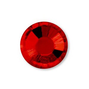 May include: A single, round, red rhinestone with a faceted surface.