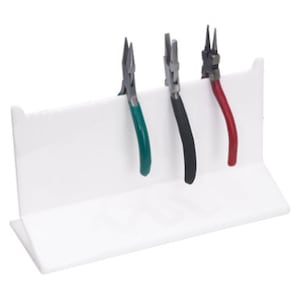 May include: White plastic stand with three pairs of pliers. The pliers have green, red, and black handles.