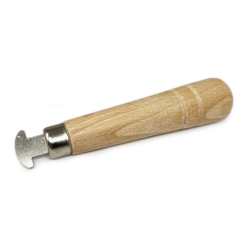 May include: A wooden handle tool with a metal T-shaped head. The tool is used for opening and closing jump rings.