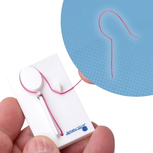May include: A white plastic tool with a pink wire loop. The tool is used to create wire jewellery. The wire is threaded through a small hole in the tool and then bent into a loop. The tool is labelled "Artistic Wire".