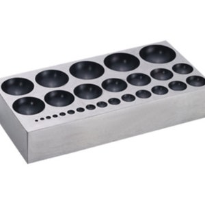 May include: A silver metal tray with a series of round depressions of varying sizes. The tray is designed for shaping metal.