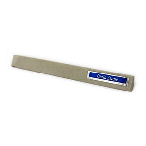 May include: A grey sharpening stone with a blue label that reads "India Stone".