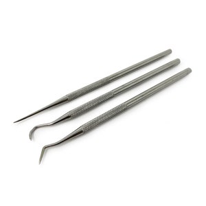 May include: A set of three silver metal tools for crafting and jewellery making. The tools have different shaped tips, including a pointed tip, a hook, and a loop.