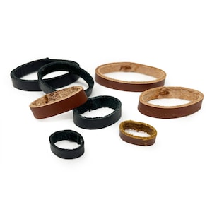 May include: Assortment of leather rings in brown, black, and tan colours. The rings are of varying sizes and are perfect for crafting projects.