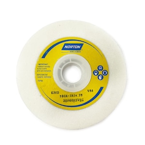 May include: A white sanding disc with a yellow label. The label has the text "NORTON SAINT-GOBAIN" and "IMPORTANT: Mount correctly. Use Guard. Do not overspeed." The label also has the text "6309 100X13X31.75 38A60K5VBE 924".