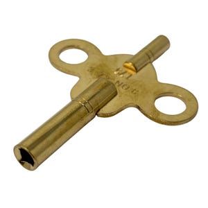 May include: A brass clock key with a double-ended design. The key has a circular handle with two eyelets and two cylindrical winding posts. The key is marked with the text "175" and "NO 6".