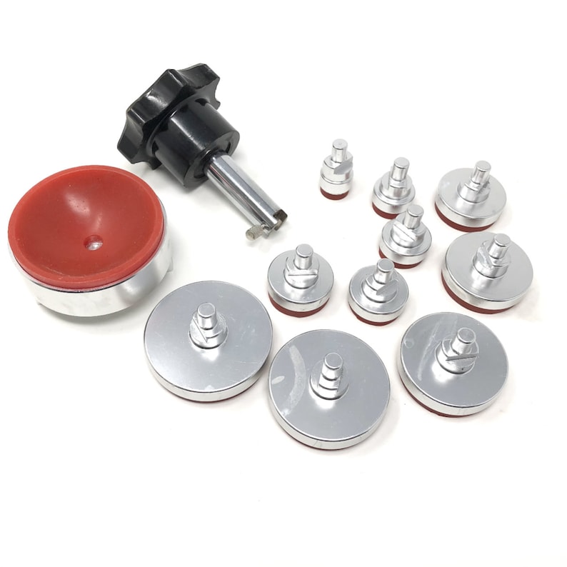 May include: A set of 10 silver-colored watch case back press tools with red rubber inserts. The tools are used to press watch case backs on and off.