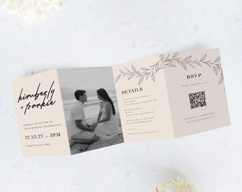 May include: A tri-fold wedding invitation with a black and white photo of a couple on the beach. The invitation features the names "kimberly + frankie" in a handwritten font, along with the wedding date and time. Floral design accents the invitation.