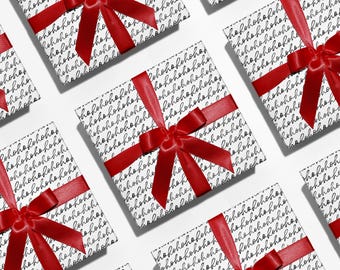 May include: Several wrapped gifts with red satin bows are arranged on a white surface. The wrapping paper is white with a repeating pattern of the word "hohoho" in a handwritten style. The gifts are ready for the holidays.