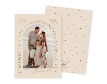 May include: A beige Christmas card with a family photo inside an arch, with the text "FOR UNTO US A CHILD IS BORN, UNTO US A SON IS GIVEN." The back of the card has a pattern of small green stars.