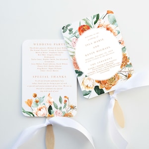 May include: Two wedding program fans with floral designs in orange, peach, and green. One fan displays the wedding party details and special thanks. The other fan has the names Isla Marie and Kevin Michael, with the ceremony details.