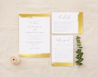 May include: Gold foil wedding invitation with a brushstroke design. The invitation includes the names Natalie and Christian, the date Saturday, the sixteenth of November, two thousand twenty, and the location Blushing Gardens, 127 Highland Avenue, Londonville, Ohio. The RSVP card includes the text "kindly respond by September 28, 2020".