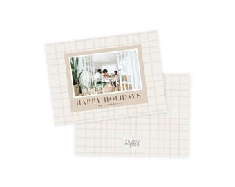 May include: Holiday greeting cards with a beige grid pattern and a family photo. The cards feature the text "HAPPY HOLIDAYS" and "THE JEFFERSONS" in a stylish font. The bottom right corner of the card has the logo "TRULY INSPIRED PAPER CO."