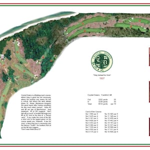 May include: A detailed aerial map of Crystal Downs golf course, featuring green fairways, red hole markers, and surrounding trees. Includes course details, yardage, and a logo with the text "Stay Below the Hole" and the year 1927.