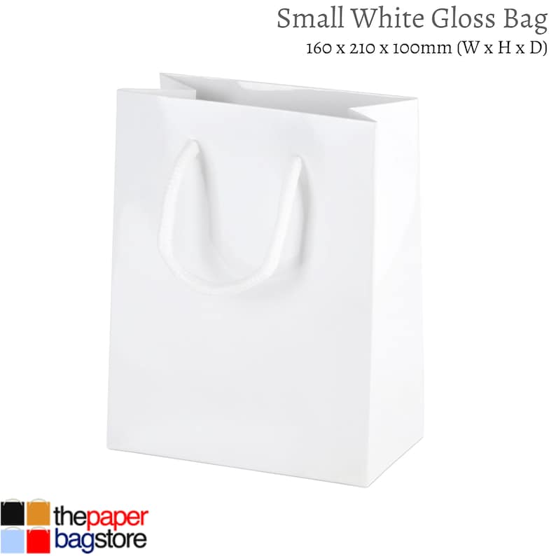 May include: A white gloss paper gift bag with white rope handles. The bag measures 6.3 inches wide by 8.3 inches high by 4 inches deep.