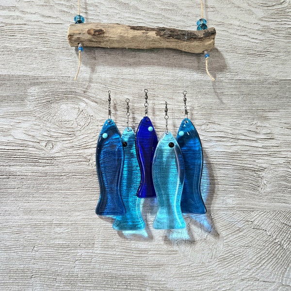 This fused glass fish windchime is hanging from a piece of driftwood.  I have used twine and added beads to match the shades of Aqua fish