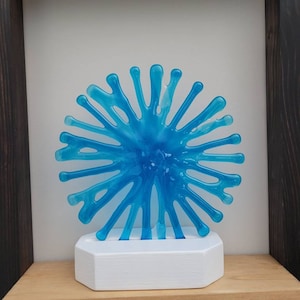 Fused Glass Abstract Coral in a wood base made with two shades of turquoise transparent fusible glass.  Wood base painted white.