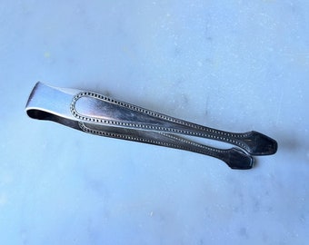 Old silver metal sugar tongs