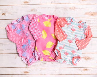 Traje de baño de una pieza de manga larga con protección solar UV40 para niñas y bebés.