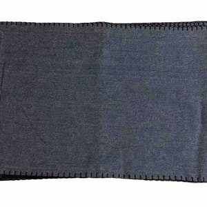 May include: A set of dark gray placemats with a stitched edge.