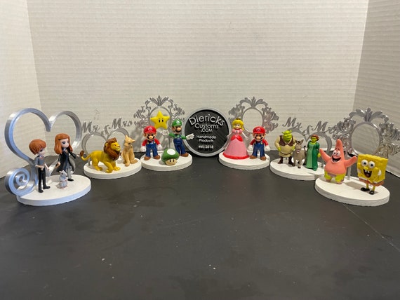 Action figure wedding cake toppers.