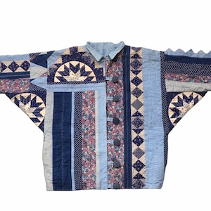 May include: A blue and white quilted jacket with a patchwork design. The jacket has a button closure and long sleeves.