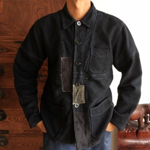 May include: A black quilted jacket with a button-up front and multiple patch pockets. The jacket is made of a textured fabric and has a relaxed fit.