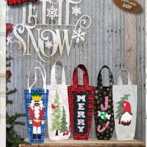 May include: Holiday-themed wine totes in various designs, including a nutcracker, Christmas tree, and gnome. The totes feature festive patterns like plaid and snowflakes, with the word "MERRY" displayed on one.