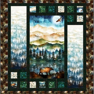 May include: A quilt block featuring a watercolor landscape with a bear, mountains, trees, and a lake. The block is surrounded by smaller blocks with various patterns, including leaves and branches.