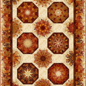 May include: A quilt with a cream background and a brown border. The quilt features eight octagonal shapes with a kaleidoscope design of fall leaves in shades of orange, brown, and red.