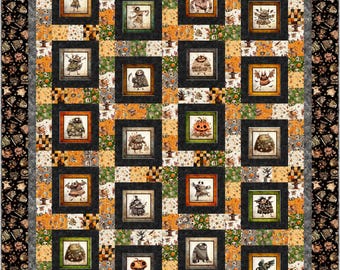 May include: A Halloween-themed quilt featuring framed illustrations of whimsical monsters and creatures. The quilt has a patchwork design with orange, green, and gray squares, and a black border with repeating spooky characters. The framed images add a unique touch to the overall design.