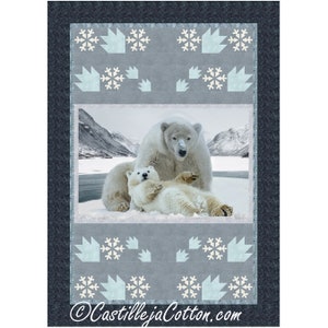 May include: A quilt pattern featuring a mother and baby polar bear in a snowy landscape. The quilt is made with a blue and white fabric with a snowflake design.