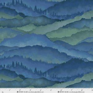 May include: A fabric print featuring layered mountain ranges in shades of blue and green with silhouettes of pine trees along the ridges. The bottom edge includes a white ruler with markings up to 9 inches and text reading HENRY GLASS.