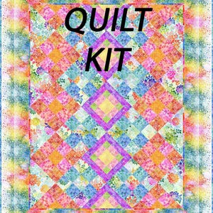 May include: A colorful quilt kit with the words "QUILT KIT" in large black letters. The quilt features a vibrant patchwork design with squares of orange, pink, blue, and purple. The border has a rainbow gradient.
