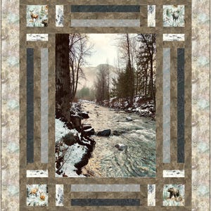 May include: A framed quilt featuring a winter river scene. The central image is a photograph of a flowing river surrounded by snow-covered banks and trees. The border includes images of wildlife, such as deer and bears, and a patterned fabric.