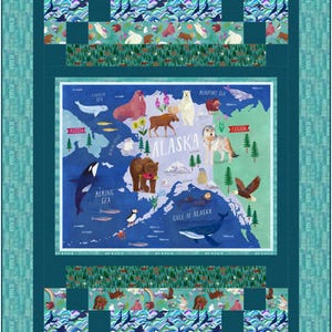 May include: A colorful quilt featuring a map of Alaska with illustrations of wildlife like bears, whales, and eagles. The quilt has a teal border with the word "Alaska" repeated. The central map is surrounded by patterned sections with animals and geometric designs.