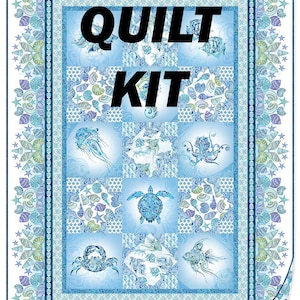May include: A blue and white quilt kit featuring sea creatures like jellyfish, turtles, and fish. The quilt has a detailed border with seashell and star patterns. The words "QUILT KIT" are prominently displayed in black.