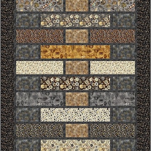 May include: A quilt block with a brick pattern featuring various shades of brown, gray, and beige. The fabric has a repeating pattern of gears, flowers, and other intricate designs.