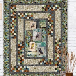 May include: A quilt with a geometric pattern featuring a variety of owls in shades of brown, grey, and white. The quilt is made with a patchwork of different fabrics in shades of green, blue, and brown.