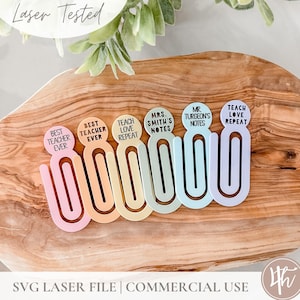 May include: Six colorful paper clip bookmarks with different teacher-themed sayings. The bookmarks are pink, orange, yellow, green, blue, and purple. The sayings include "Best Teacher Ever", "Teach Love Repeat", "Mrs. Smith's Notes", "Mr. Turgeon's Notes", and "Teach Love Repeat".