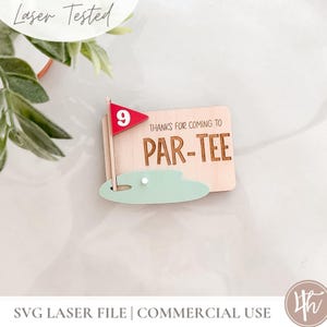 May include: A rectangular wooden sign featuring a golf theme with a light green putting green cutout, a red flag with the number 9, and the engraved text "THANKS FOR COMING TO PAR-TEE". The design includes a small white golf ball detail.