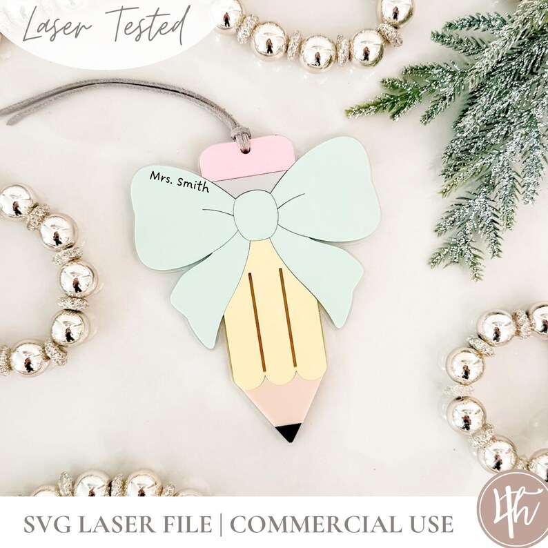 May include: A wooden pencil-shaped ornament with a light blue bow and a pink top. The pencil is yellow with a pink eraser and black tip. The text "Mrs. Smith" is printed on the ornament. The words "Laser Tested" and "SVG LASER FILE | COMMERCIAL USE" are also visible.