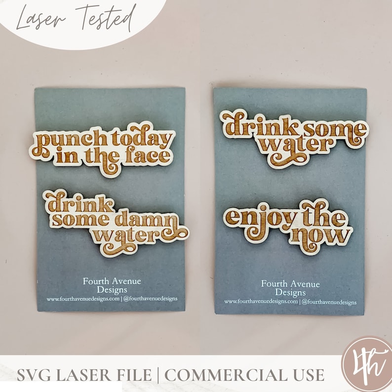 May include: Four laser-cut wooden signs with motivational phrases. The signs read "punch today in the face", "drink some damn water", "drink some water", and "enjoy the now".